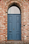  Blue front door on historic brick house 