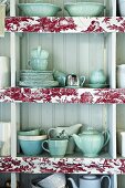 Open wall cabinet containing crockery
