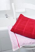 Two cushions on chair in bathroom