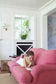 Girl reading on comfortable sofa