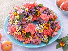 Wreath of late summer flowers on plate