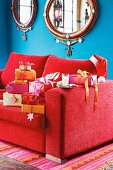 Christmas gifts on a red sofa