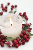 Frosted glass with candle and wreath of haws