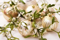 Christmas baubles amongst mistletoe