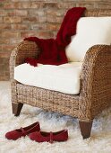 Rattan armchair and red ladies' shoes on flokati rug