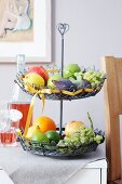 A wire etagere filed with fruit