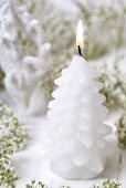 Fir cone candle among baby's breath