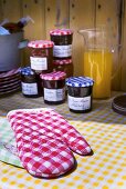 Oven mitts and jars of home-made jam