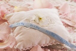 Rose-scented pillow with horned violet & pale blue ribbon