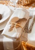 A Easter place setting: serviette decorated with a feather