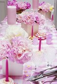 Laid table with pink accessories and peonies