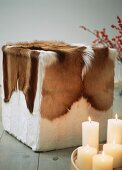 Cube stool covered with animal skin