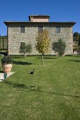 Mediterranean country home with stone facade and garden