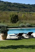 Deckchair at poolside with a view of the surrounding countryside
