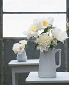 White peonies in a white jug