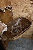 A wooden wash basin in the corner of a rustic house