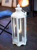White lantern with burning candle