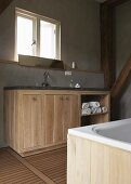 A dignified bathroom - a washstand with a wooden cupboard against a grey wall