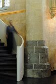 A person coming down a flight of stairs in a church