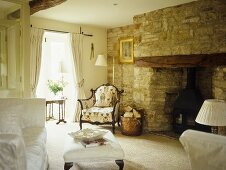 Living room fireplace with an exposed stone wall.