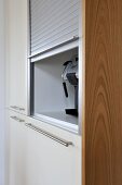 Storage with shutter in fitted kitchen unit