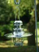 Chrome and glass candle lantern hanging from pole