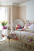 A traditional bedroom with a brass bedstead, a crocheted rug and a bedside table
