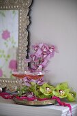 Filled champagne glasses and orchid flowers on a silver tray