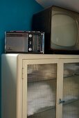50s style radio and TV on a display cabinet