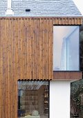 Vertical wood panelling on a newly built house with floor-to-ceiling windows