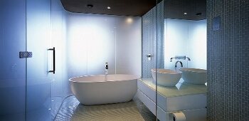A designer bathroom with a free-standing bathtub