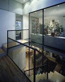 A modern transparent stairwell with a view into a living room