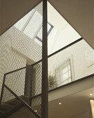 A transparent stairwell with a view through a skylight