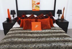 Decorative cushions and a quilt on a bed on a double bed