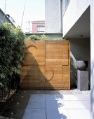 A wooden partition wall with a modern relief pattern on the terrace of a house