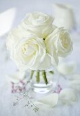 A bunch of white roses in a glass vase