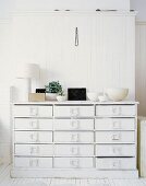 A white chest of drawers