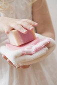 Girl holding soap and towel