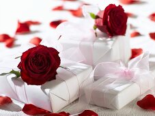 Gifts in white wrapping paper with red roses