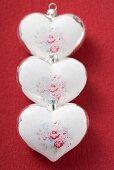 Three silver hearts with rose motifs (Xmas tree ornaments)