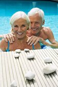 Germany, Senior couple in pool, close-up