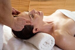 Woman receiving facial massage