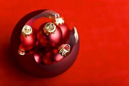 Broken Christmas bauble filled with small red baubles