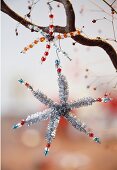 Close-up of decorative Christmas stars on branch