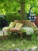 Wooden tree bench with scatter cushions