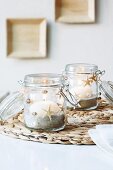 Preserving jars with maritime decoration used as candle lanterns