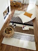 View down into living room with rug & beanbag in front of fireplace