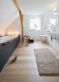 Modern, attic bathroom with fitted bathtub