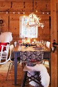 A dining table laid for Christmas dinner in a rustic room