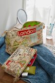 A wash bag and a make-up bag made from fabric printed with a map of London
